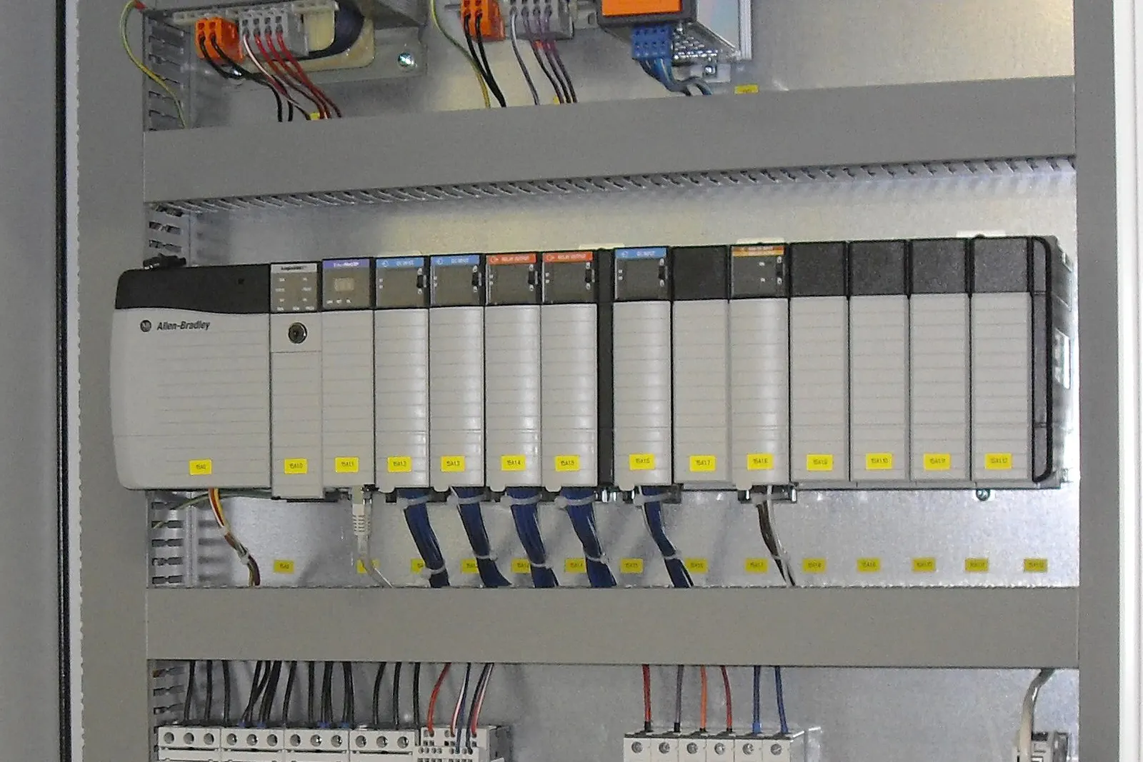 Industrial control panel with programmable logic controller modules and labeled wiring
